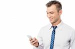 Businessman Reading A Funny Sms Stock Photo