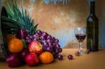 Fruits And Wine Bottles On Wooden Stock Photo