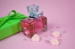 Pink Aromatic Perfume With Green Vintage Gift And Pearls And Roses On Pink Background Stock Photo