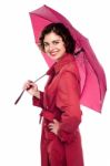 Glamorous Woman Standing Under Pink Umbrella Stock Photo