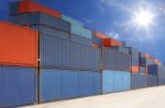 Stack Of Cargo Containers At Container Yard With Sunbeam Stock Photo
