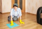 Woman Cleaning The Floor With A Rag Stock Photo