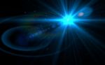 Abstract Burst Lens Flare Over Black Background Stock Photo