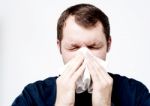 Sick Man Blowing His Nose Stock Photo
