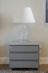 Lamp On Grey Table In Bedroom Stock Photo