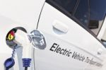 White Electric Car Charging Stock Photo