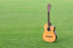 The Classic Guitar Is A Musical On The Grass Background Stock Photo