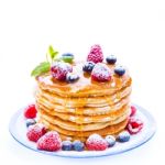Pile Of Pancakes With Blueberries And Raspberries Sprinkled With Stock Photo
