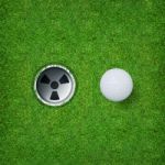 Golf Ball And Golf Hole On Green Grass Of Golf Course Stock Photo