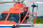 Offshore Helicopter Pilot Is Standing On Helicopter Cockpit Stock Photo