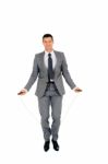 Businessman Jumping Rope Stock Photo
