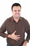 Young Man Suffering From A Bad Stomach Ache Pain Isolated On Whi Stock Photo