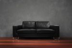 Black Sofa With Wooden Floor Concrete Wall In Empty Living Room Stock Photo