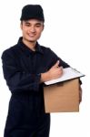 Smiling Delivery Man At Your Doorstep Stock Photo