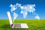 Laptop On Grass And Social Network Structure Stock Photo