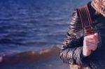 Young Woman Hand On Her Backpack, Sea Background Stock Photo