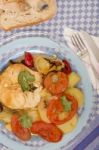 Fish With Potatoes And Tomato Stock Photo