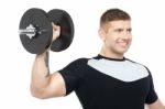 Muscular Male Showing His Biceps By Lifting Heavy Dumbbell Stock Photo