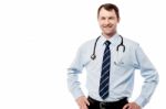 Happy Male Doctor Hold Hands On Hips Stock Photo