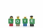 Studio Shot Of Lego Minifigure Holding Word Love On White Background Stock Photo