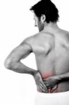 Young Man Holding His Lower Back In Pain Stock Photo