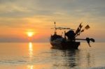 Fishing Boat With Sunrise Backdrop Stock Photo