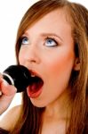 Close View Of Woman Singing Into Karaoke Stock Photo