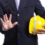 Engineer Holding Helmet On White Background Stock Photo