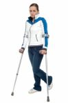 Pensive Looking Woman Using Crutches To Walk Stock Photo