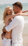 Young Couple Hugging At Beach Stock Photo