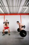 Group Of Two People Exercising Using Barbells In Gym And Kettleb Stock Photo