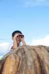 Happy Little Boy Exploring Outdoors Clambering On A Rock With Te Stock Photo