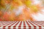 Picnic Table With Blurred Autumn Leaves Background Stock Photo