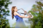 Beautiful Woman Wear Blue Evening Dress Sound Saxophone Over Mou Stock Photo