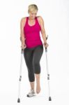 Fitness Woman With Crutches Stock Photo