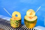 Pineapple And Melon Fruit With Straws At Swimming Pool Stock Photo