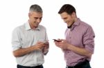 Young Casual Men Using Their Smart Phone Stock Photo