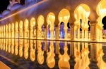 Beautiful Walkway Illuminated At Night In Abu Dhabi Sheikh Zayed Grand Mosque, Uae Stock Photo