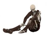 Skeleton sitting in floor Stock Photo