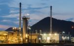 Oil Refinery Industrial At Sunset Stock Photo