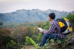 Tourists Look At A Map On The Tablet On Mountain Stock Photo