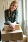 Young Beautiful Woman Moving In A New Home Stock Photo