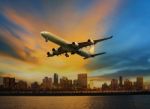 Passenger Plane Flying Above Urban Scene Use For Convenience Air Stock Photo