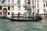 Gondolier Ferrying People In Venice Stock Photo