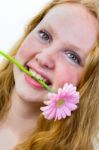 Face Of Girl With Pink Flower In Her Mouth Stock Photo