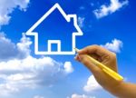 Hand Drawing House Icon On Blue Sky Stock Photo