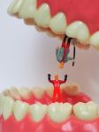 Miniature Worker On Plastic Teeth Of Removable Denture. Dental H Stock Photo