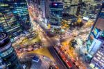 Traffic Speeds Through An Intersection At Night In Gangnam, Seoul In South Korea Stock Photo