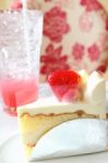 Piece Of Strawberry Cake On White Plate With Cool Drink Stock Photo