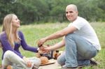 Couple Sitting In Blanket Smiling With Picnic Mode Stock Photo